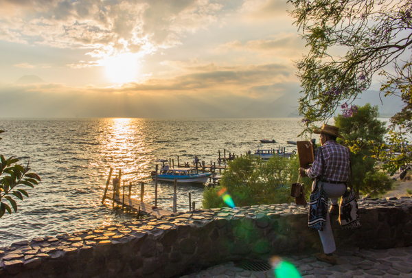 A local watches the sunset from Panajachel.