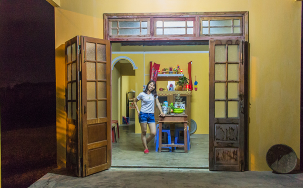 Bong standing outside of her house. 